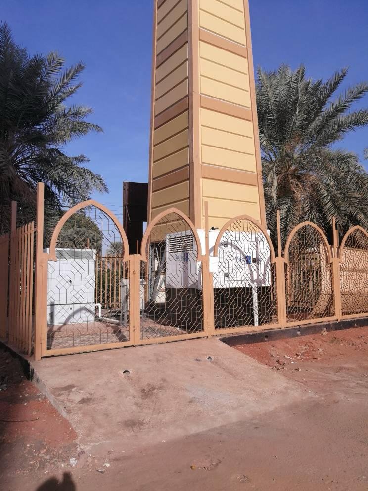 Clock tower site with decorative arched fence, Sudan