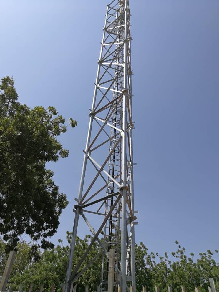 Galvanised lattice tower among trees, Sudan