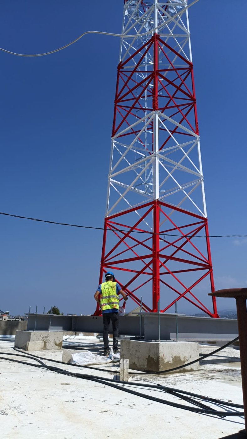 GTC technician working on a lattice tower installation, Lebanon