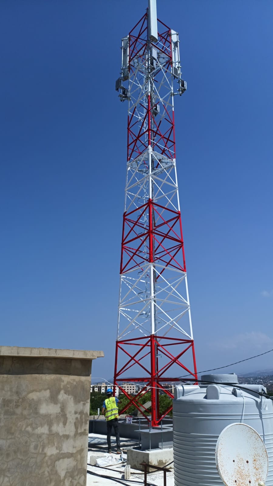 Red and white rooftop lattice tower