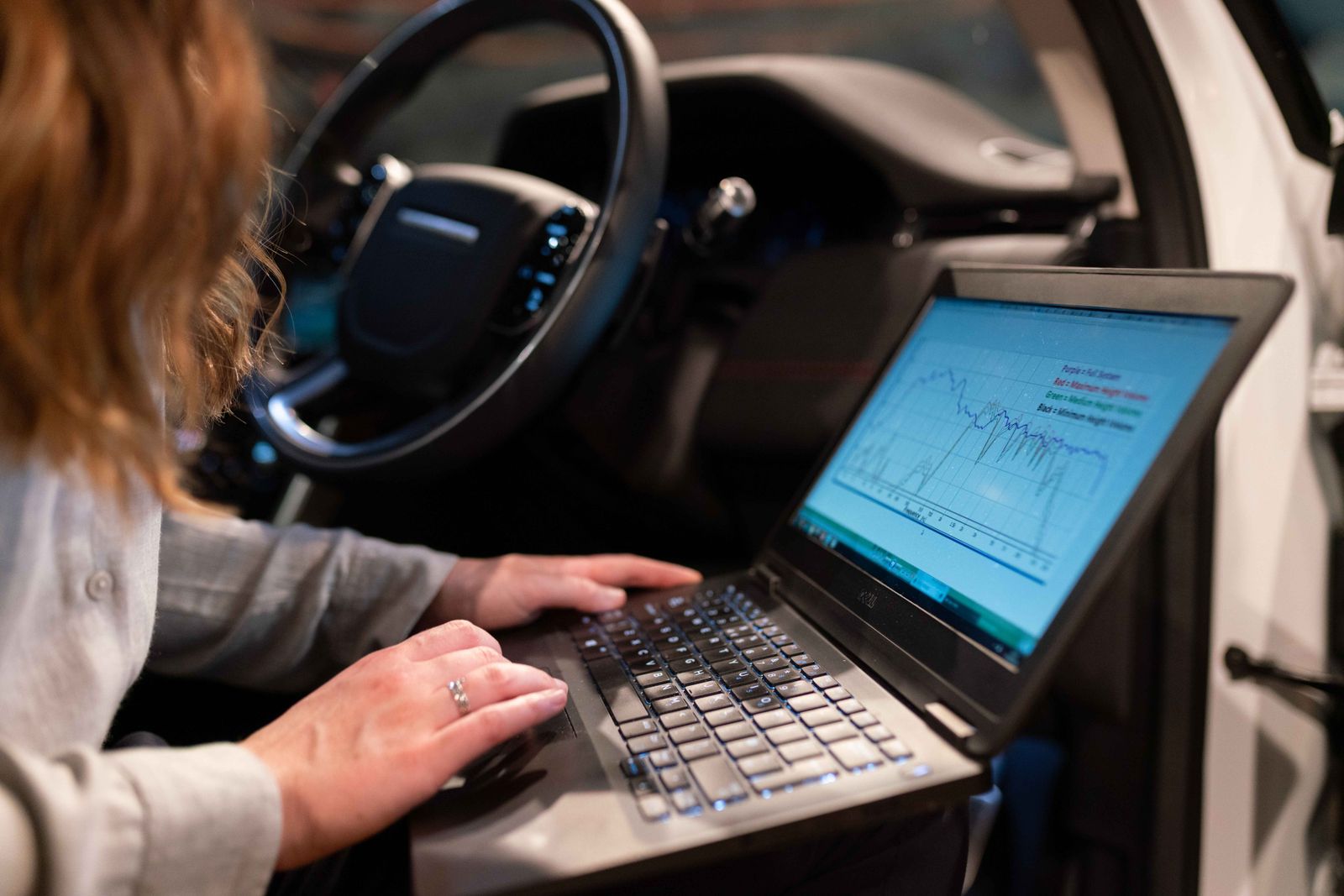 Engineer analyzing network performance data on a laptop